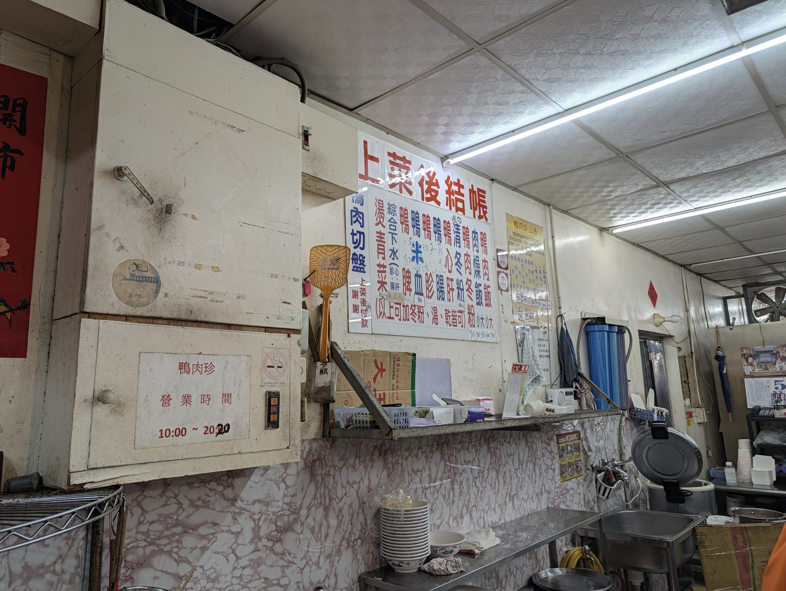 鴨肉珍の店内の営業時間(10:00〜20:20)の掲示とメニュー